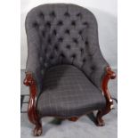A Victorian mahogany framed low armchair with black button back upholstery on cabriole supports.