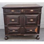 A Charles II oak chest with three long geometric moulded drawers on bun feet, 91cm wide x 84cm high.