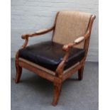 An early 19th century French style faux walnut open armchair, on sabre front supports,
