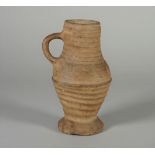 A Rhineland pottery mug, probably 15th century, of ribbed baluster form with lobed foot, (a.f), 15.