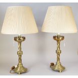 A pair of Victorian Gothic style brass alter candlestick table lamps,