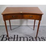 A 20th century mahogany concave fronted two drawer side table, 87cm wide x 79cm high.