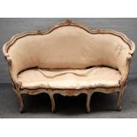 A Louis XV style parcel gilt green painted tub back sofa, on scroll supports,