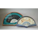 An 18th century framed paper fan, hand painted with classical scenes,