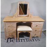 A 20th century pine dressing table with six drawers about the knee and swing frame mirror,