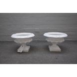 A small pair of Victorian white painted cast iron jardinieres with lobed bodies,