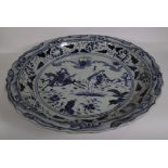 A very large Chinese blue and white Ming style dish, modern, painted with two figures on horseback,