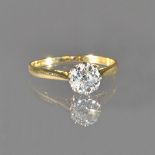 A gold and diamond single stone ring, claw set with a cushion shaped diamond, ring size M,