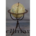 A 20th century globe, on a wrought iron stand, 55cm wide x 98cm high.