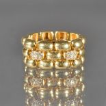 A gold and diamond chain link ring, in a three row domed oval link design,