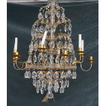 A Baltic style gilt metal and cut glass twelve light chandelier, with plain arms and nozzles,