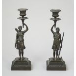 A pair of 19th century bronze figural candlesticks; Diana the huntress and one other,