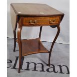 An Edwardian mahogany single drawer drop flap side table on sabre supports,