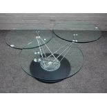 A 20th century occasional table with three glass tiers, on revolving ebonised base, 42cm high,