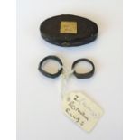 Two Ancient bronze signet style intaglio rings, possibly Roman, with a later oval case, (2).