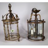 A Victorian style gilt brass hall lantern of circular form with pillar supports and single light