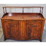 A 19th century Continental mahogany side cabinet with two drawers over moulded cupboard doors on