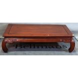 A 20th century Chinese hardwood low table, the rectangular top on inswept supports,