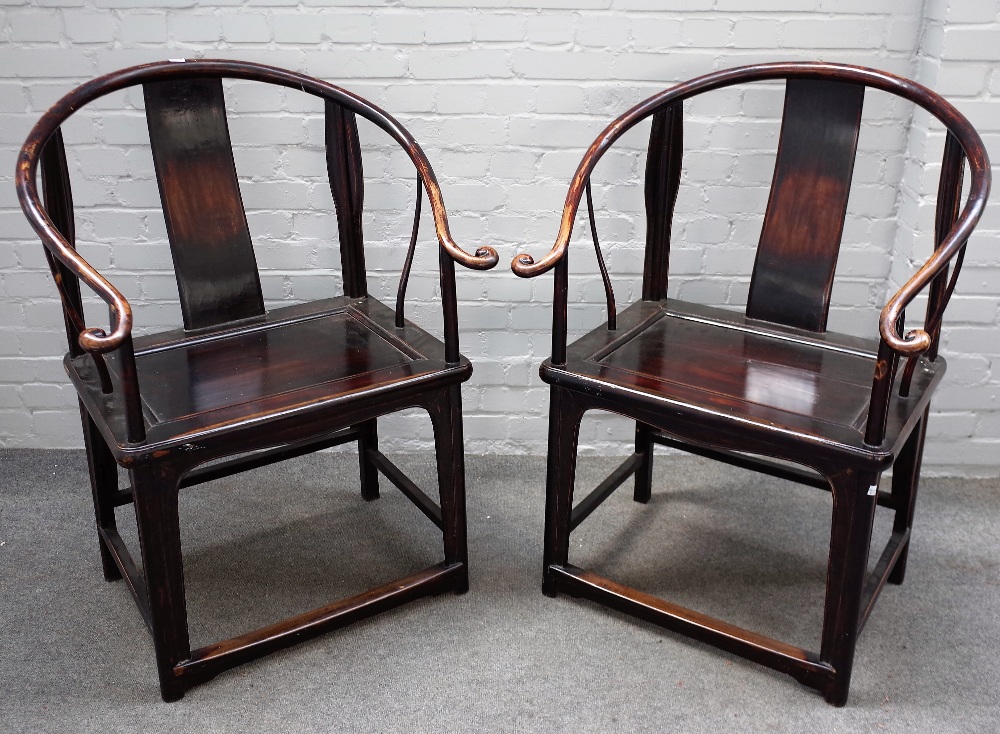 A pair of 19th century Chinese hardwood horseshoe back armchairs,