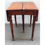 A small Regency mahogany drop flap concertina action extending table, on five turned supports,