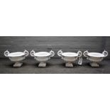 A set of four Victorian white painted cast iron twin handle garden urns, 40cm wide x 26cm high.