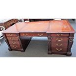 After Chippendale, a modern mahogany pedestal desk with nine frieze drawers and opposing cupboards,