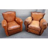 A pair of 20th century French brown leather upholstered easy armchairs on block supports,