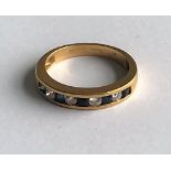 An 18ct gold, sapphire and diamond half-hoop ring,