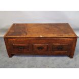 A 20th century hardwood low trunk with three drawers, 120cm wide x 47cm high.