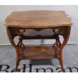 An Edwardian walnut three tier shaped side table, 77cm wide x 67cm high,