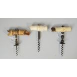 Three mid 19th century straight pull corkscrews, each with tunred bone handle,