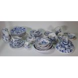 A composite group of blue and white `Onion' pattern porcelain and pottery, late 19th/ 20th century,