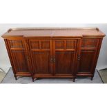 An Edwardian walnut breakfront bookcase with four panelled doors, 189cm wide.