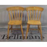 A pair of 20th century beech stick back dining chairs, (2).