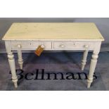 A late Victorian white painted two drawer side table on tapering supports, 105cm wide x 73cm high.