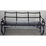 A 19th century black painted strap iron garden bench, 148cm wide x 75cm high.