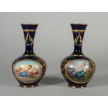 A pair of `Vienna' blue-ground bottle vases, circa 1900, painted with titled scenes,