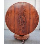 A William IV rosewood centre table, the circular snap top on tapering column and three paw feet,