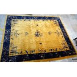 A Chinese carpet, the golden field with sprays of indigo flowers and butterflies, vases and sprigs,