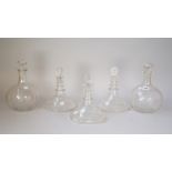 A pair of engraved glass decanters and stoppers, each bulbous body engraved with a sailing vessel,