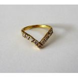 An 18ct gold and diamond ring, in a wishbone shaped design,