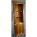 A 20th century pine floor standing corner cabinet, with recessed top over cupboard base,