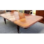 A William IV mahogany extending dining table, on bulbous carved baluster supports, two extra leaves,