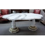 A 20th century marble centre table, the shaped top on a pair of gilt metal mounted baluster columns,