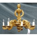 An 18th century style eight branch giltwood chandelier, modern, of carved foliate form, 66cm high.