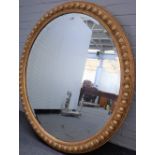 A large late 19th century gilt framed oval wall mirror with egg and dart moulded frame,