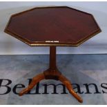 A late Louis XVI brass mounted mahogany tripod occasional table with octagonal snap top,