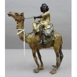 A Bergman style Austrian cold painted bronze depicting a nubian male, seated on a camel,