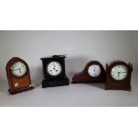A group of three French clocks, including a mahogany lancet shaped mantel clock,