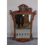 A George III mahogany framed pier mirror with ho ho bird crest, 53cm wide x 90cm high.